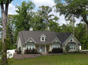 One story residential home with board siding on the facade.